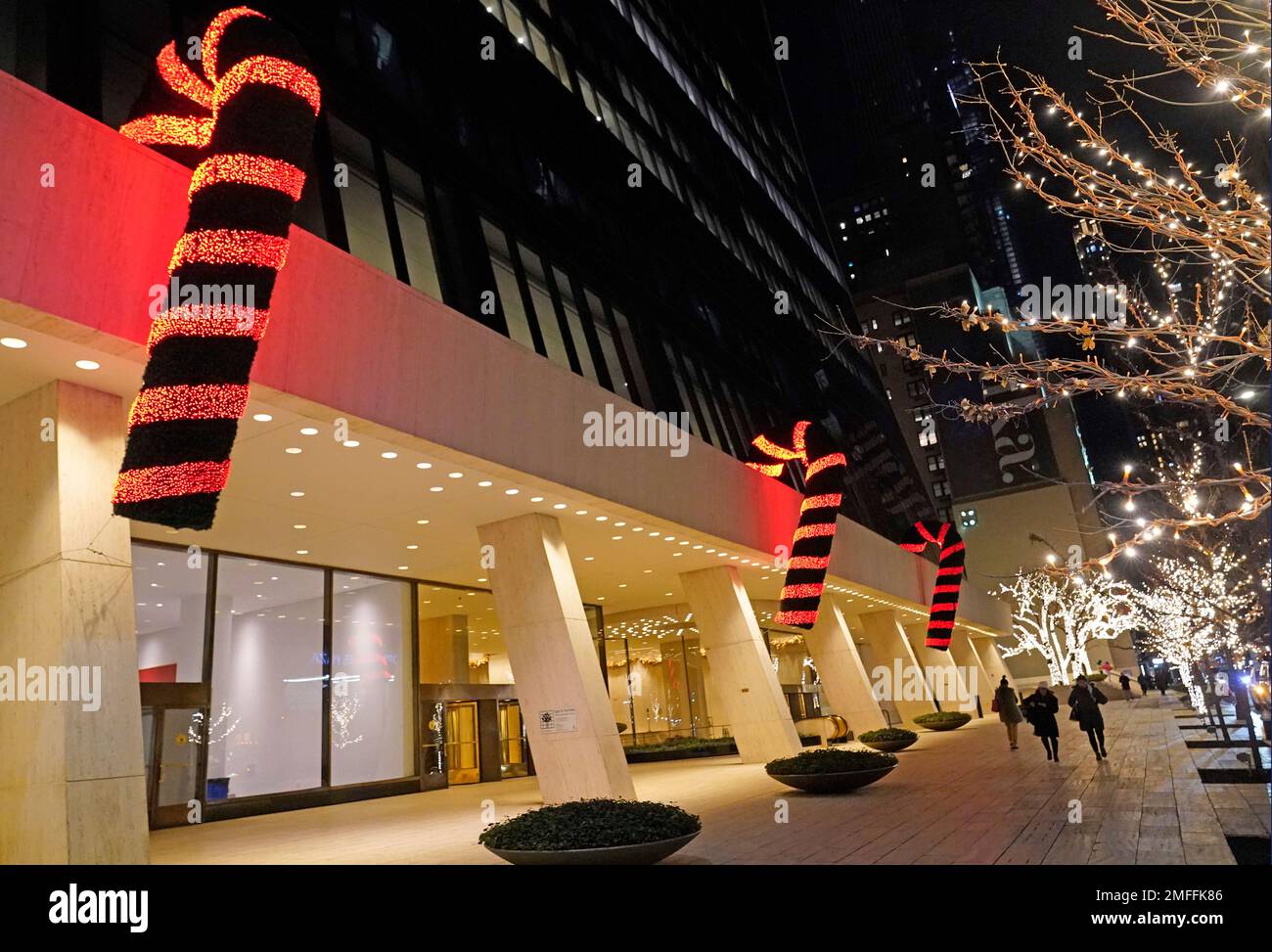 Giant candy canes are suspended from an overhang on a midtown Manhattan