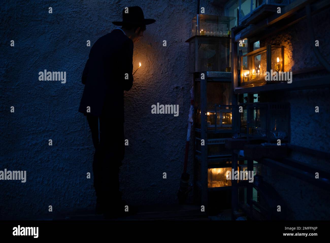 An ultraOrthodox Jewish yeshiva student lights candles on the first