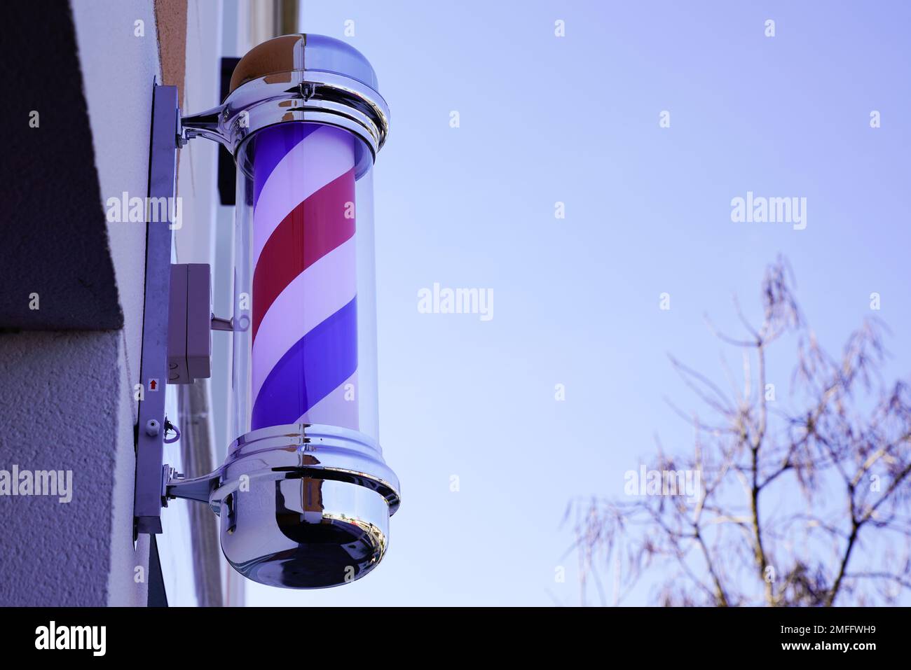 barber pole shop brand sign in wall facade hairdresser in chrome white
