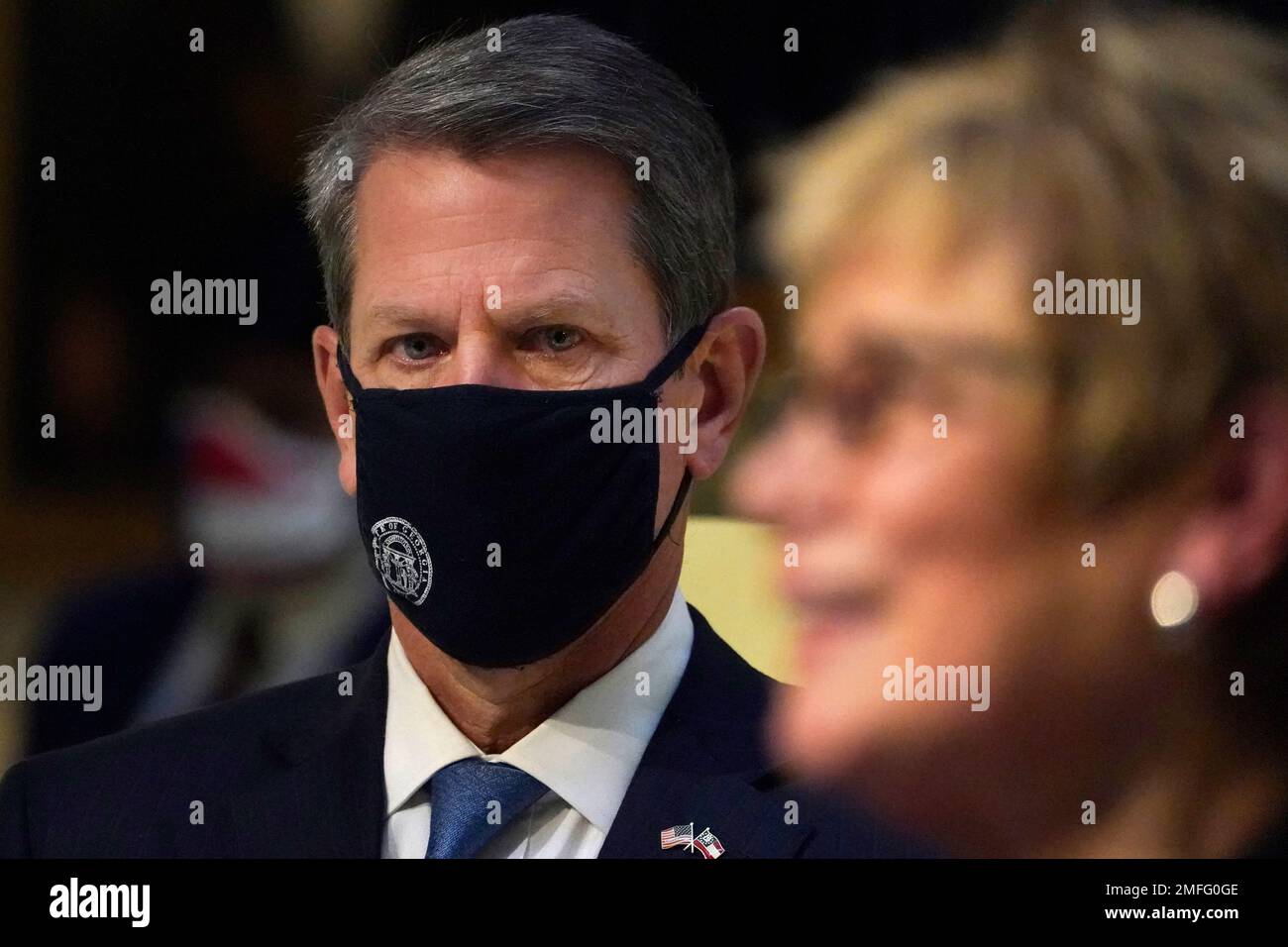 Georgia Gov. Brian Kemp looks on as Commissioner of Department of ...