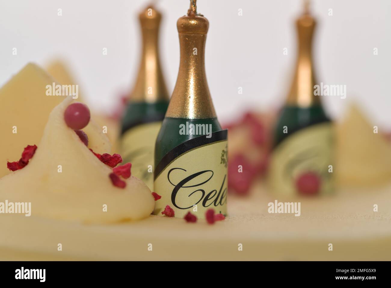 Champagne shaped birthday candles sitting on top of a Birthday Cake