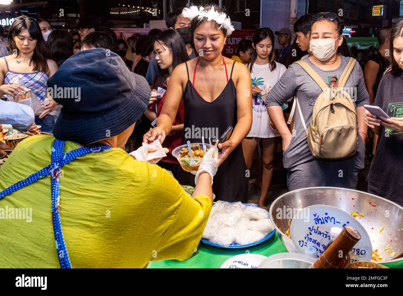 Food vendors and customers at street market at night in Pattaya, Thailand Stock Photo