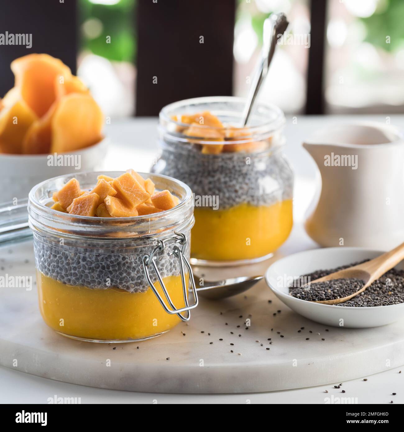 A close up of homemade chia pudding parfaits on a marble slab, ready for eating. Stock Photo