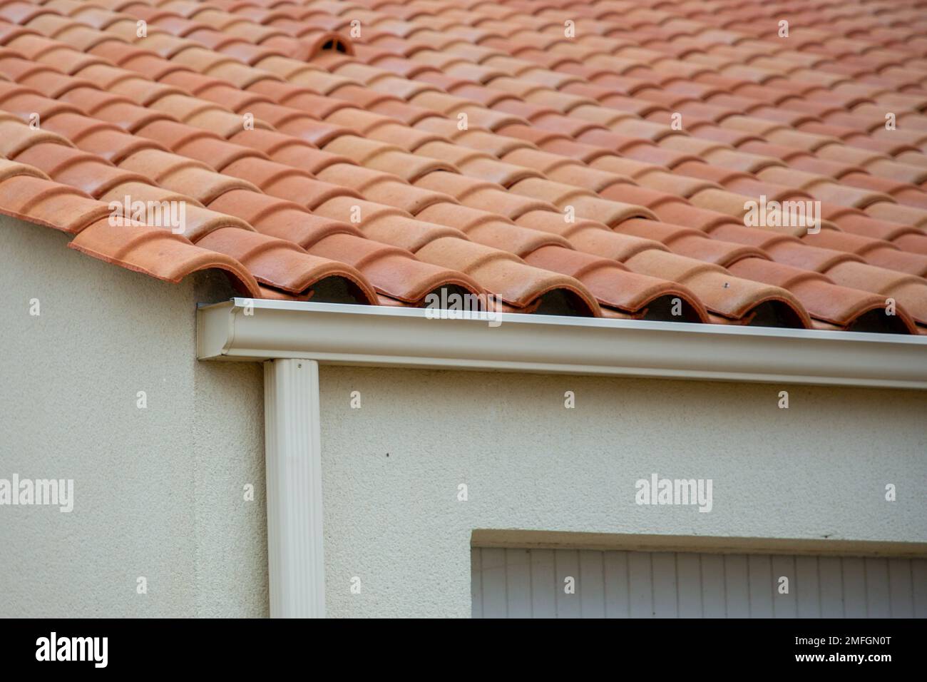 white gutter guard system fascia drip edge on single family home neighborhood Stock Photo Alamy