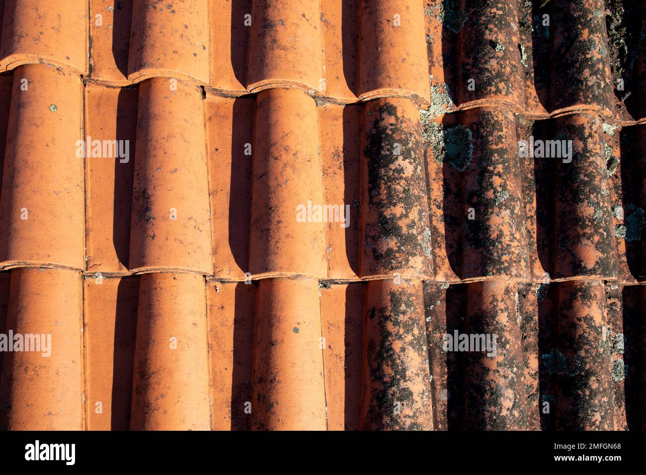 Roof cleaning tiles with high pressure cleaner and before afterwards