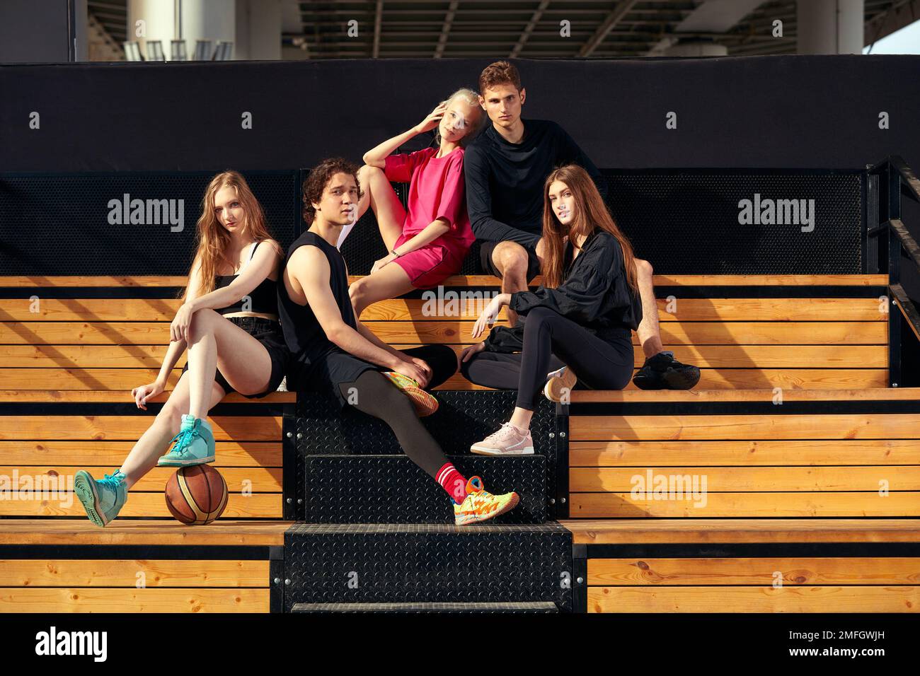 A group of cheerful young people girls and guys are discussing and ...