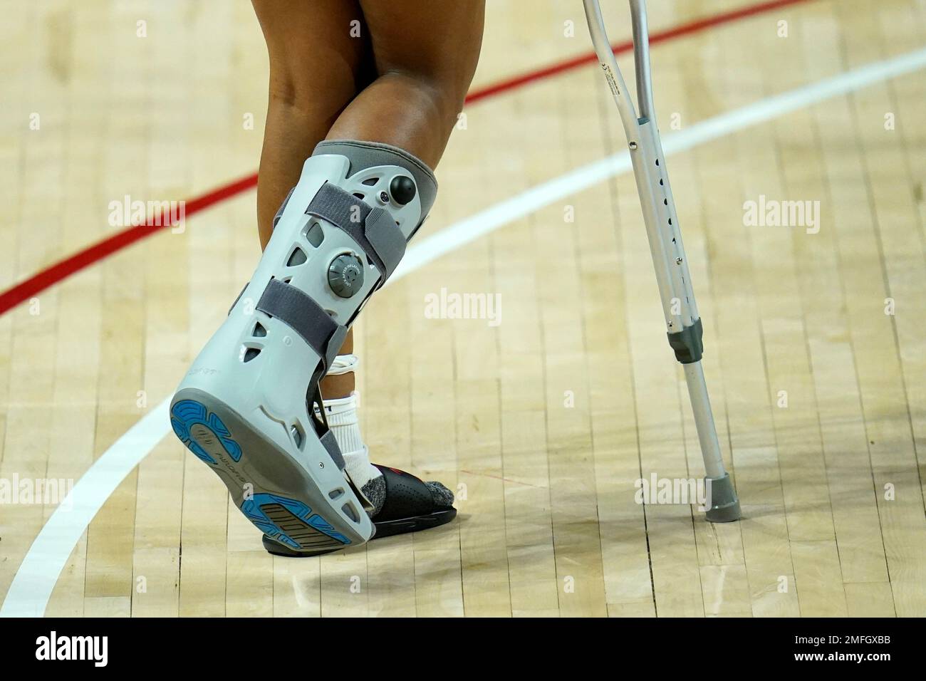 Maryland forward Angel Reese wears a boot while walking on crutches