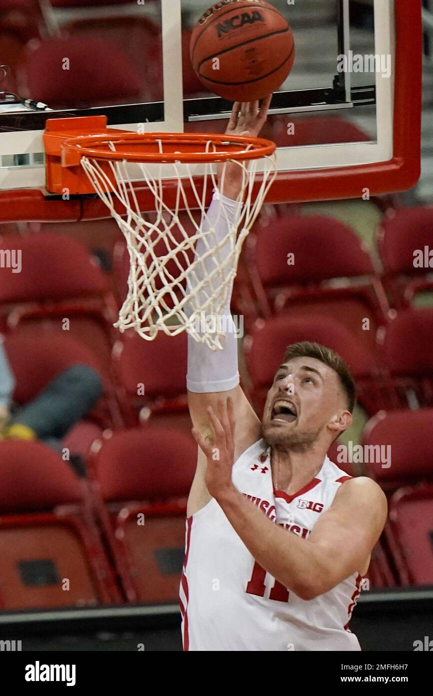 Wisconsin's Micah Potter shoots during the first half of an NCAA