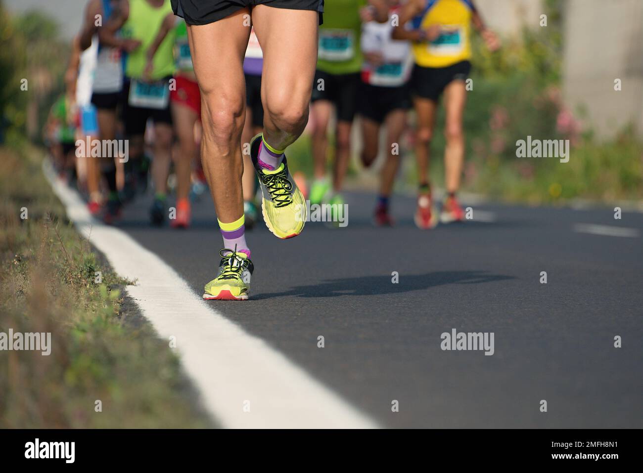 Marathon running race, runners feet on road Stock Photo Alamy