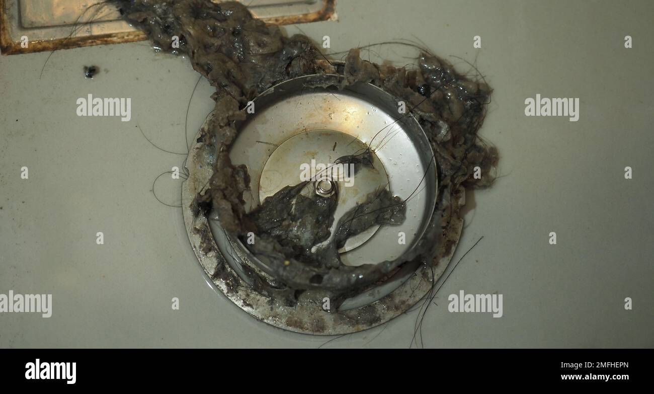 Drain cleaning. Clogged and dirty sewer pipes floor drain. Full of hair