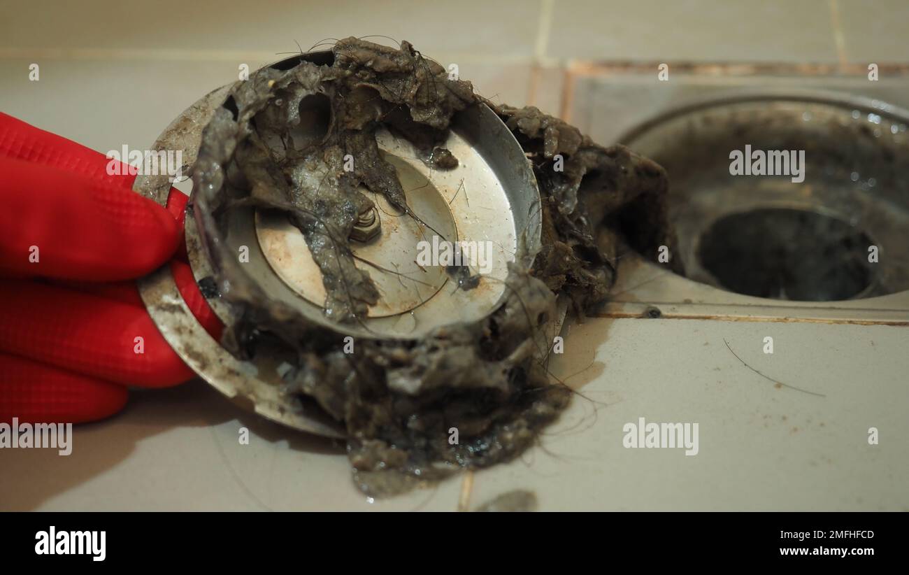 Drain cleaning. Clogged and dirty sewer pipes floor drain. Full of hair and accumulated clogged