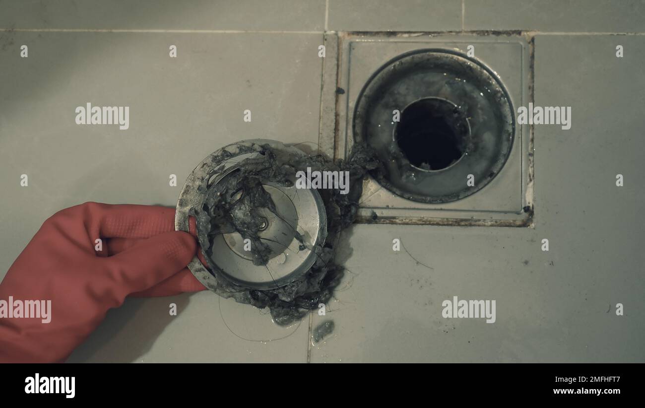 Drain cleaning. Clogged and dirty sewer pipes floor drain. Full of hair