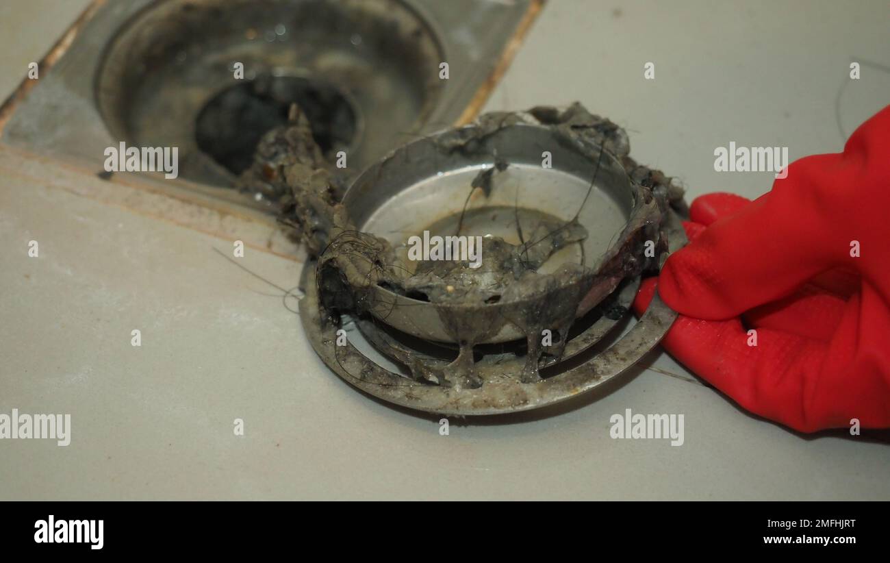 Drain cleaning. Clogged and dirty sewer pipes floor drain. Full of hair and accumulated clogged