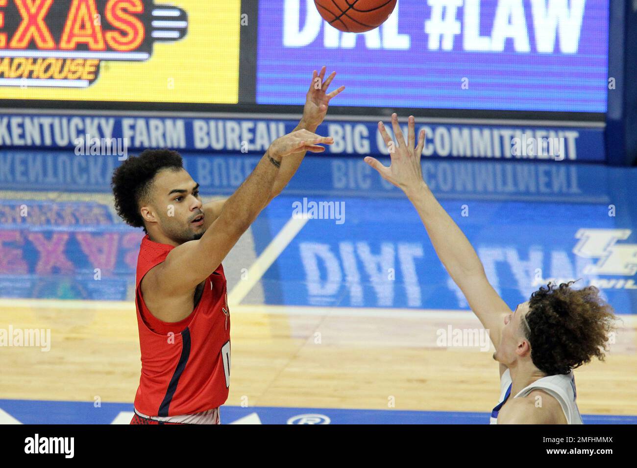 Richmond's Jacob Gilyard, left, shoots while defended by Kentucky's