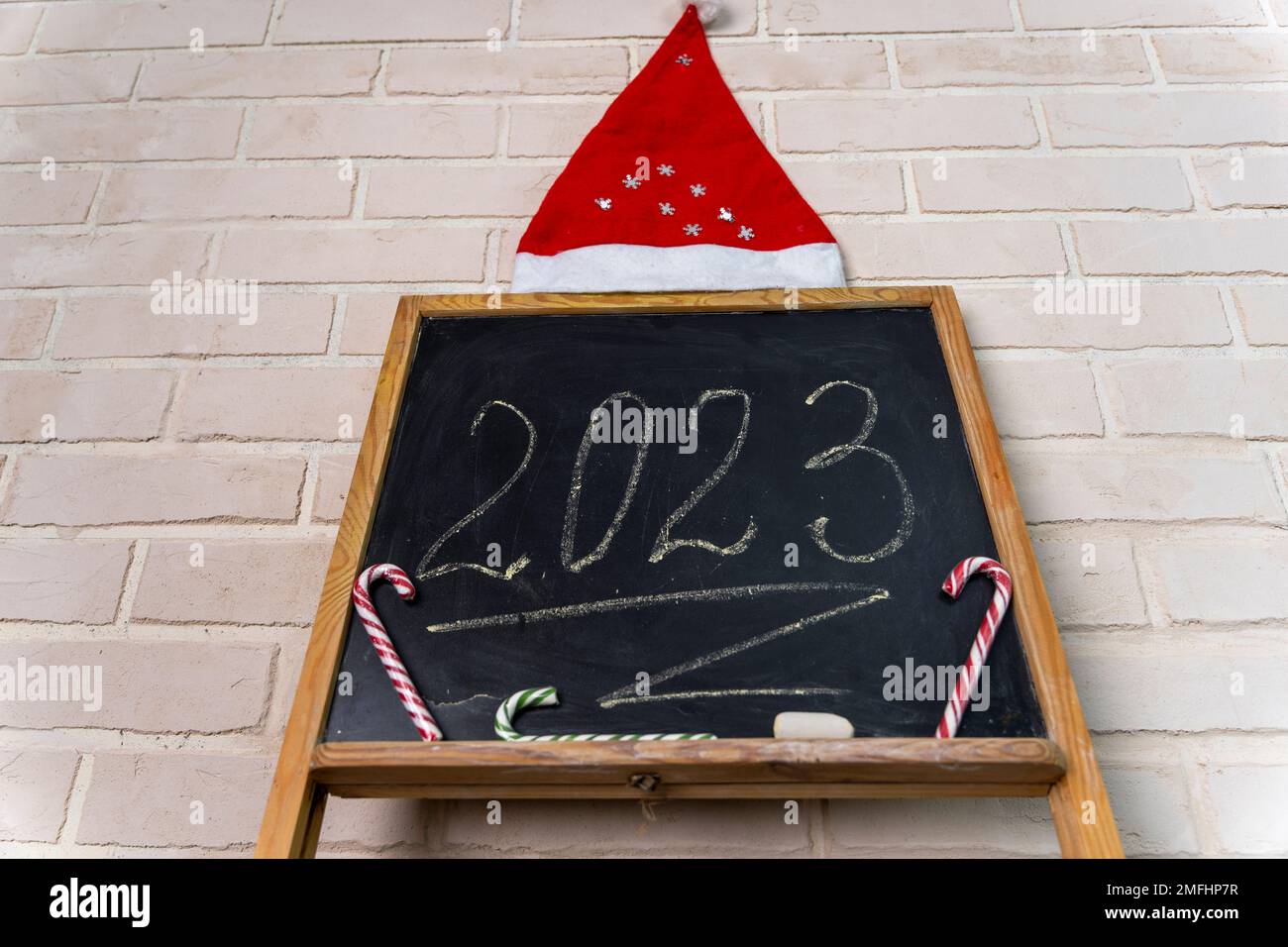 a black slate on which the year 2023 is written in chalk. Happy New Year. Stock Photo