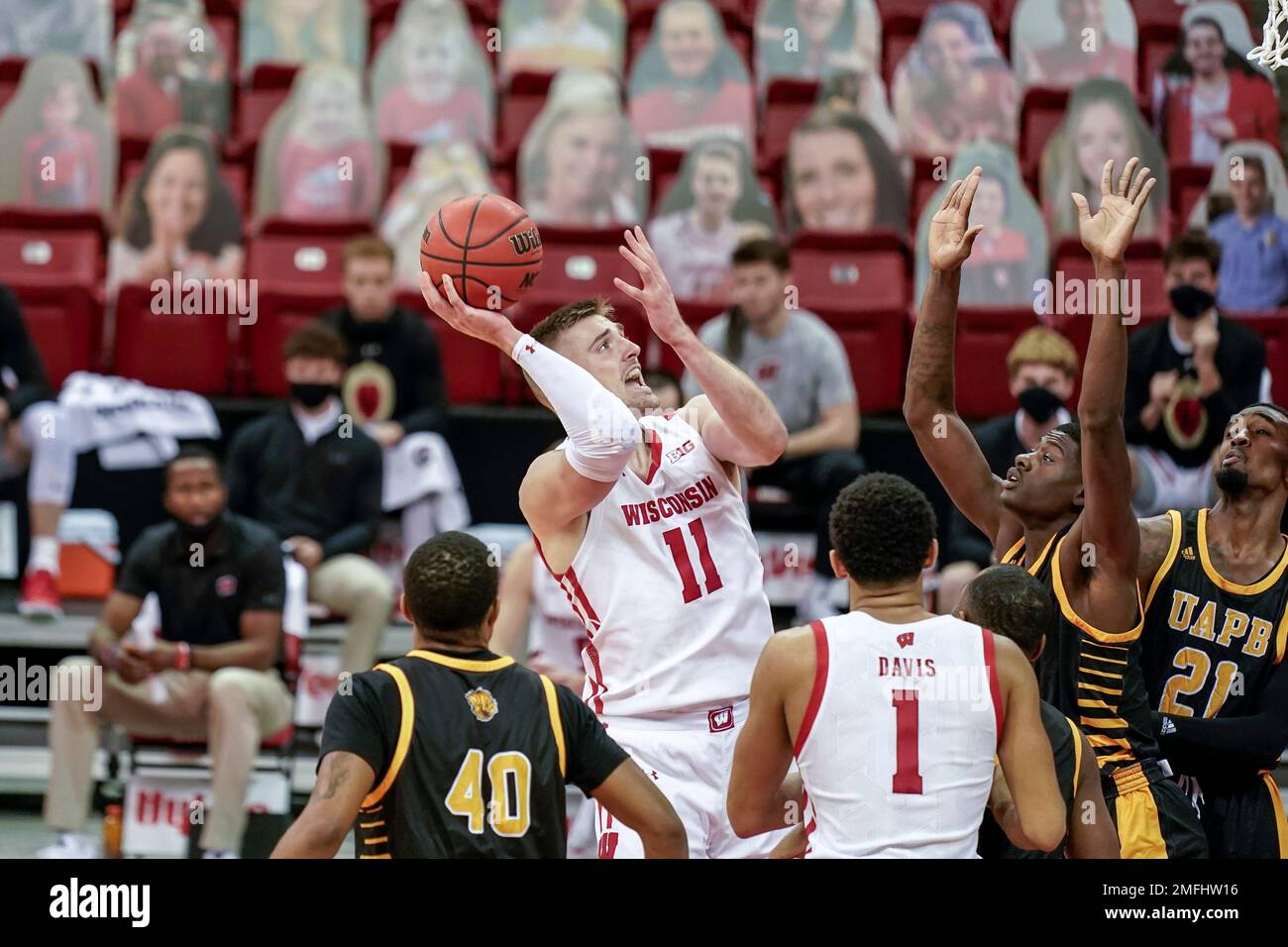 Wisconsin's Micah Potter (11) and ArkansasPine Bluff's Markedric Bell
