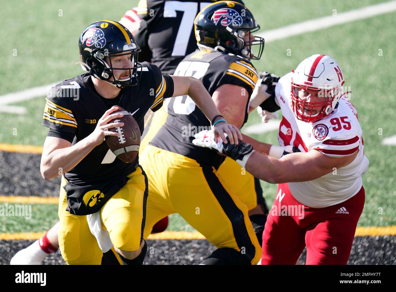 Iowa quarterback Spencer Petras (7) runs from Nebraska defensive