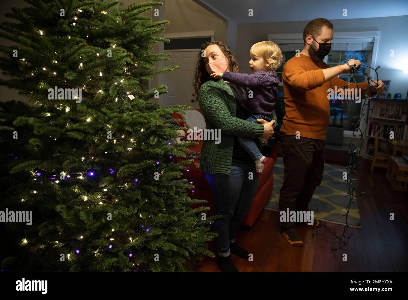 Ani Sirois , a respiratory nurse puts lights and decorations on the