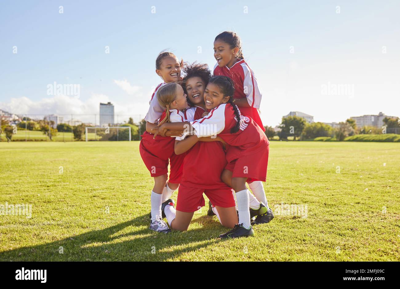 Success, soccer or winner children team hug in stadium for sports exercise, sport game or workout training. Teamwork, Canada or kids in celebrating Stock Photo