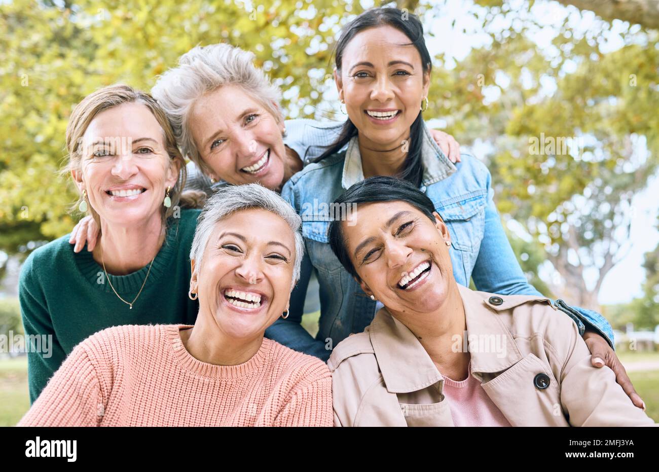 Smile, park and portrait of group of women enjoying bonding, quality time and relax in nature together. Diversity, friendship and faces of happy Stock Photo