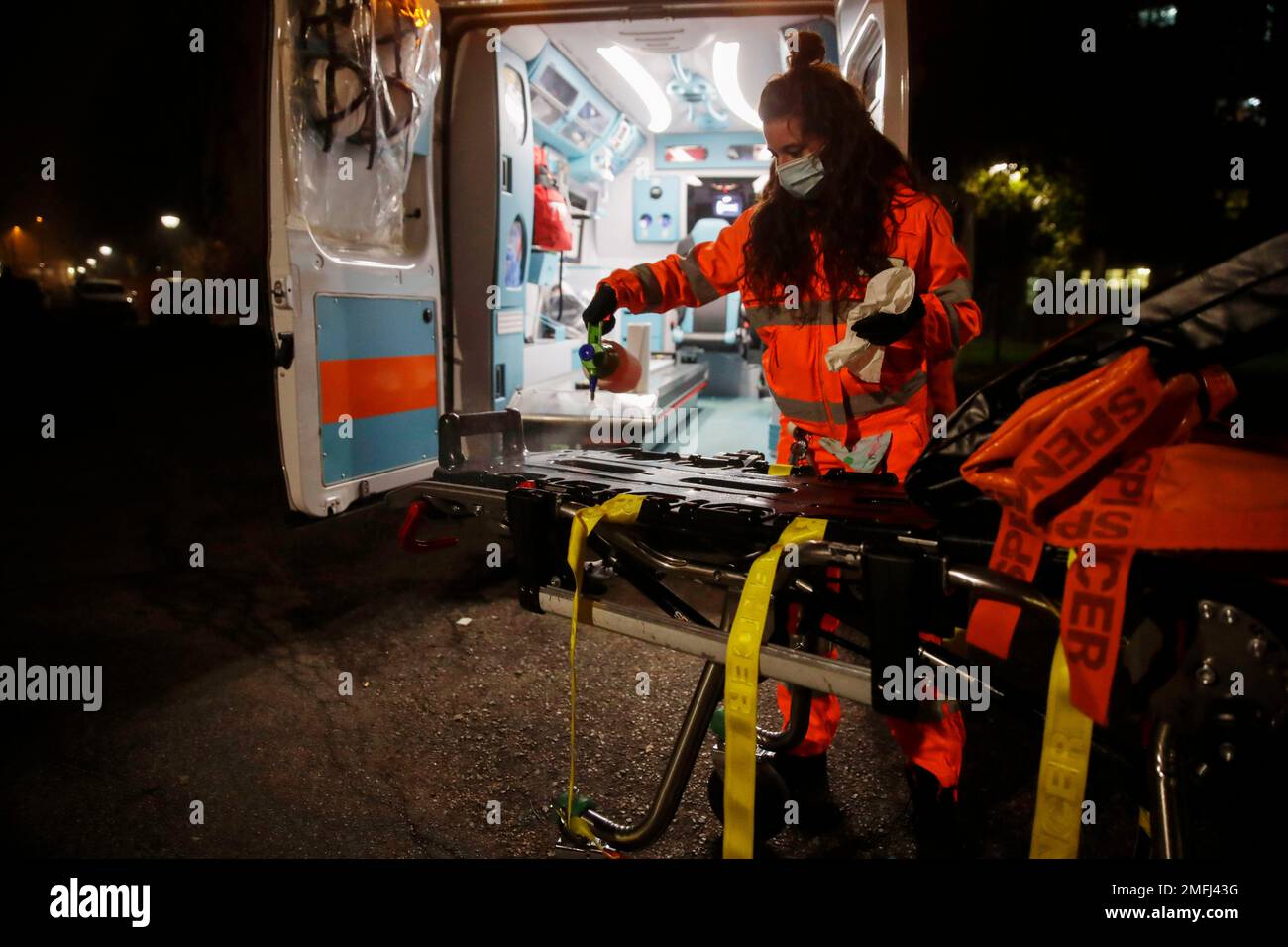 Medical volunteer Beatrice Ammattatiello sanitizes the ambulance