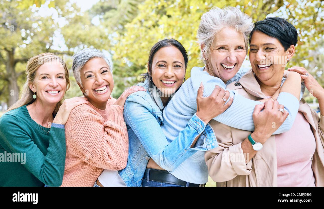Friends, park and group of women hug enjoying bonding, quality time and ...