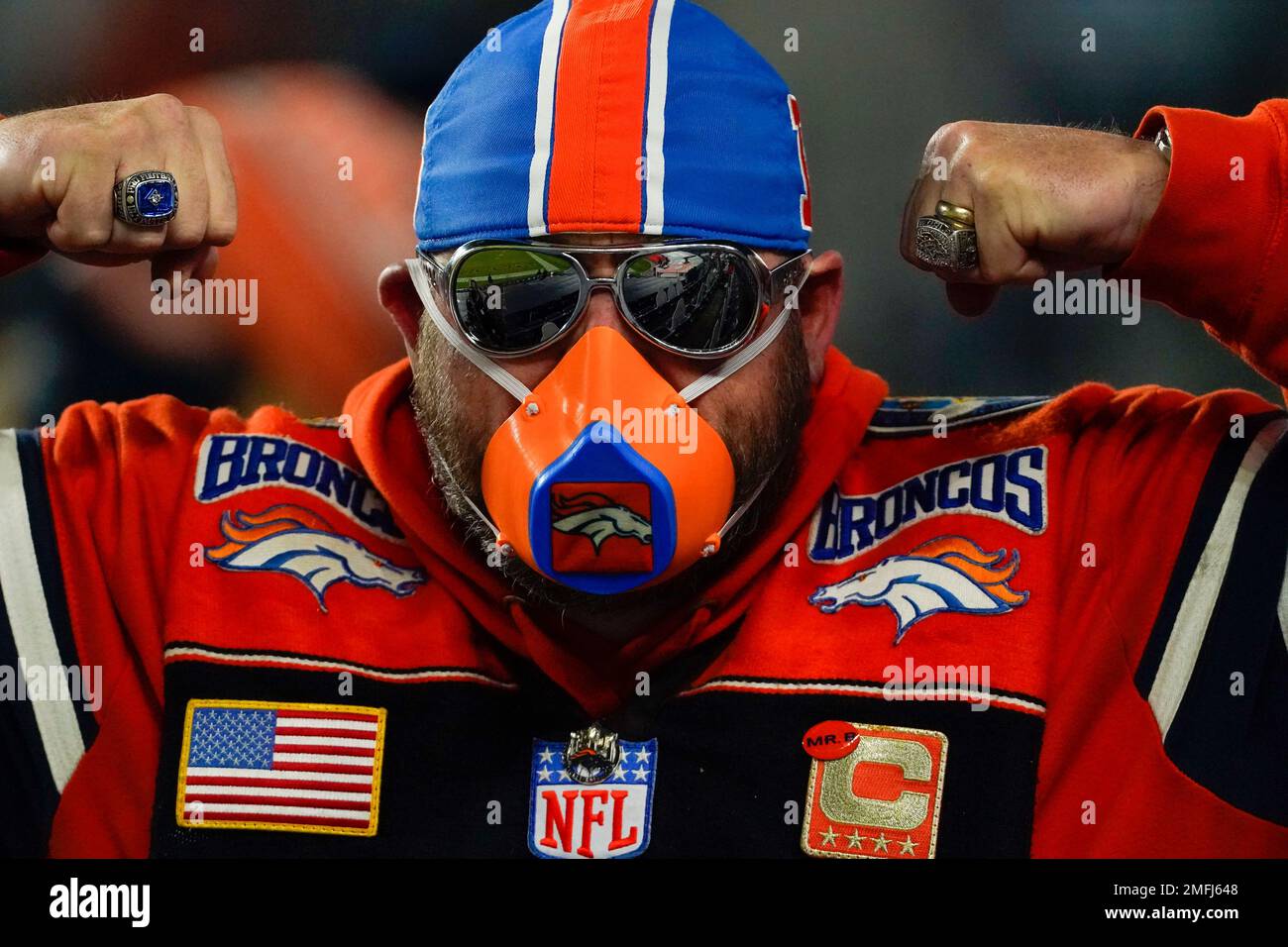 Denver Broncos super fan Randy Emons flexes wearing a mask during