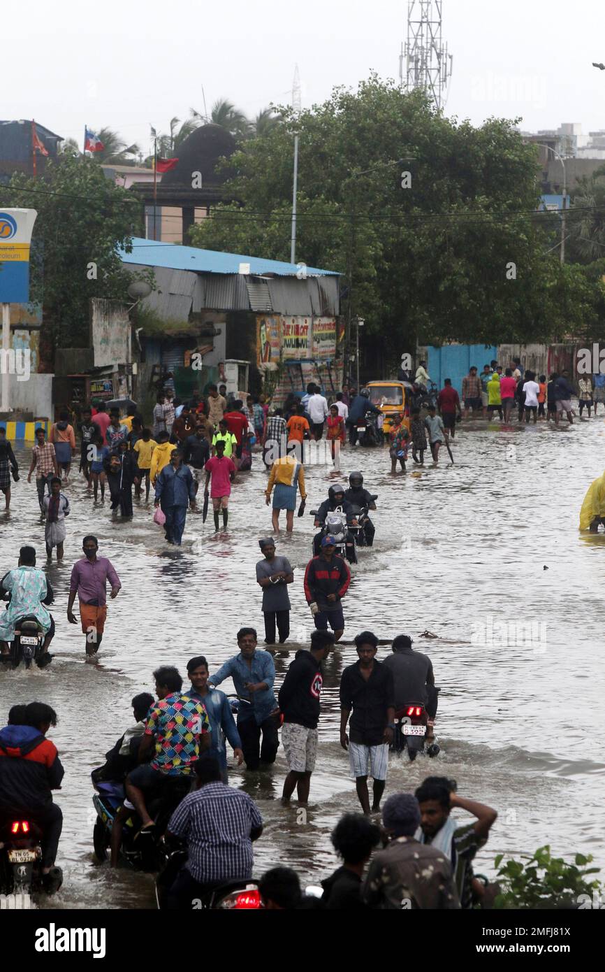 People wade through a flooded street in Chennai, India, Wednesday, Nov ...