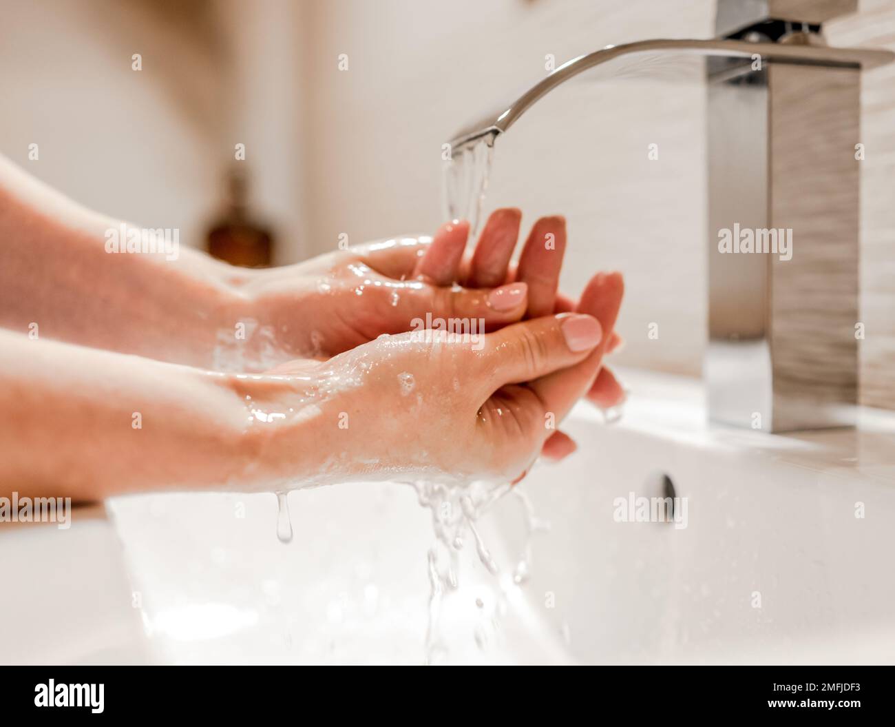 Girl washing hands with soap in bathroom Stock Photo - Alamy