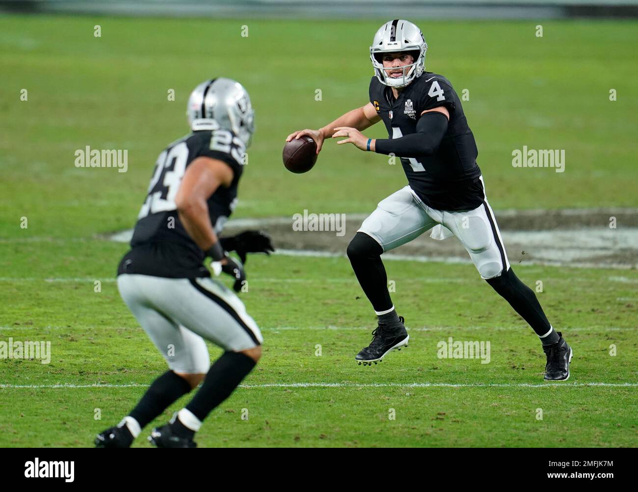 Las Vegas Raiders quarterback Derek Carr 4 rolls out to pass during