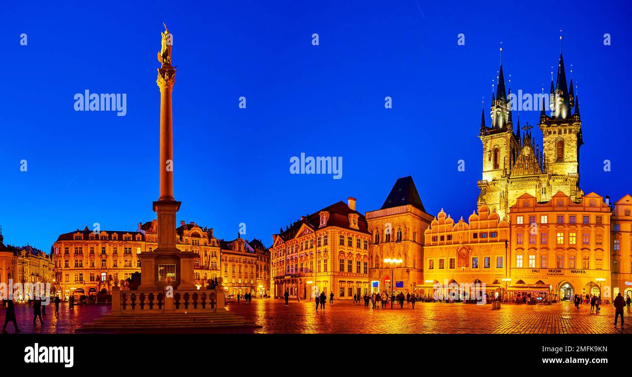 PRAGUE, CZECHIA - MARCH 11, 2022: Panorama of Old Town Square with Marian Columna and towers of Tyn chuach in night illumination, on March 11 in Pragu Stock Photo
