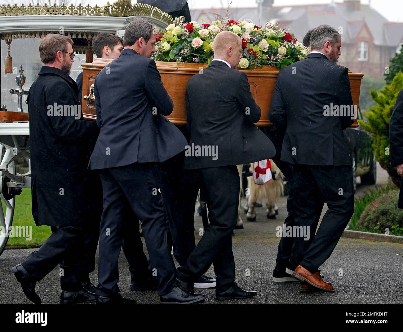 The bearer party, including father Tim Edwards (right), carry the