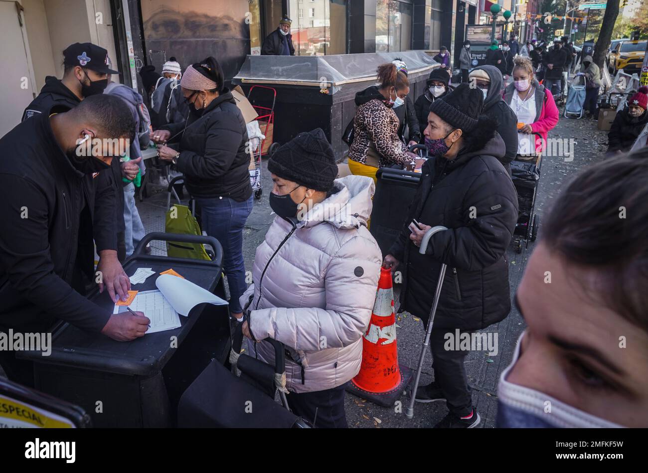 People line up and checkin for a food giveaway at Harlem's Food Bank