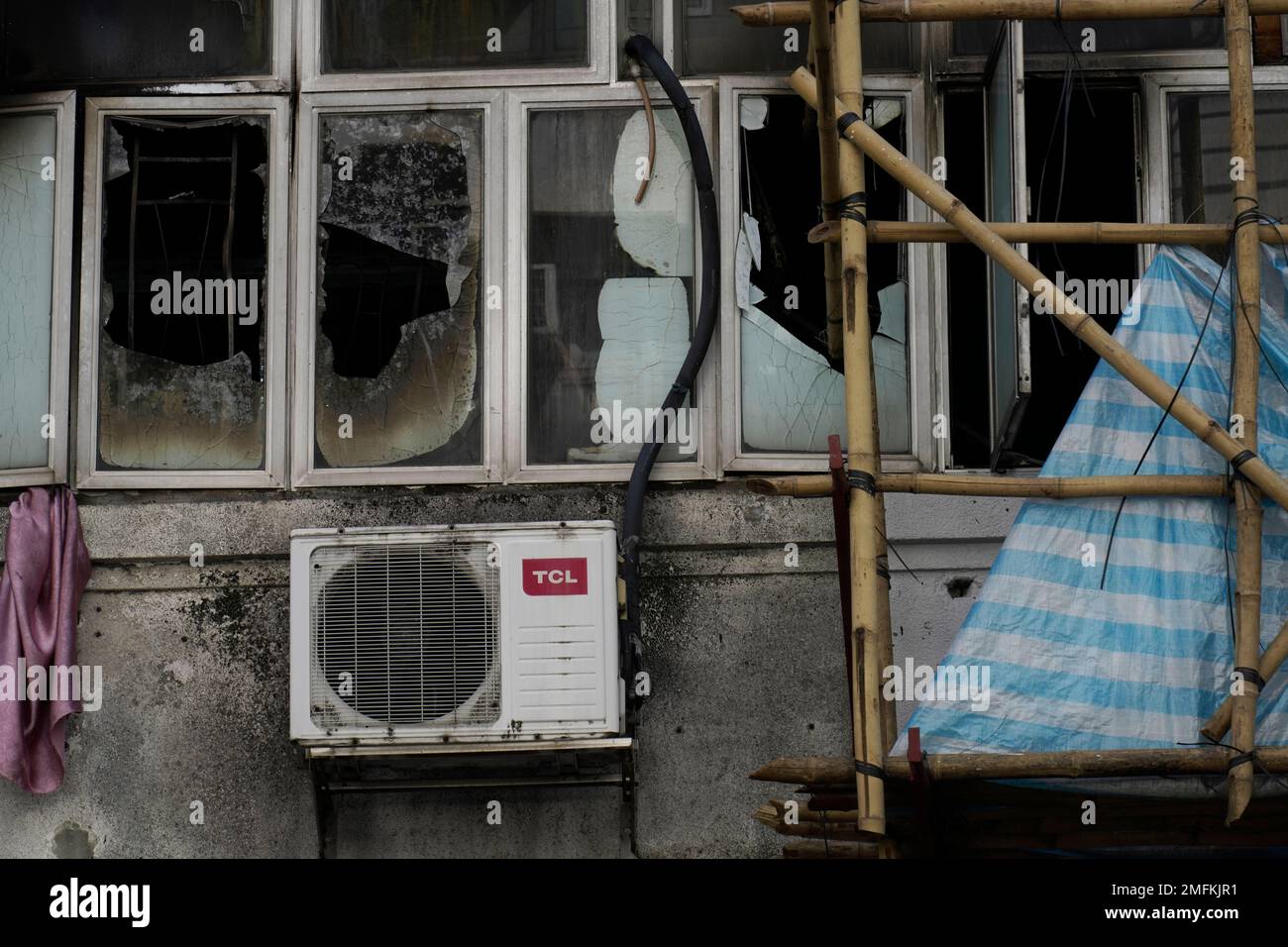 A broken window is seen at a fire site in Hong Kong Monday, Nov. 16 ...