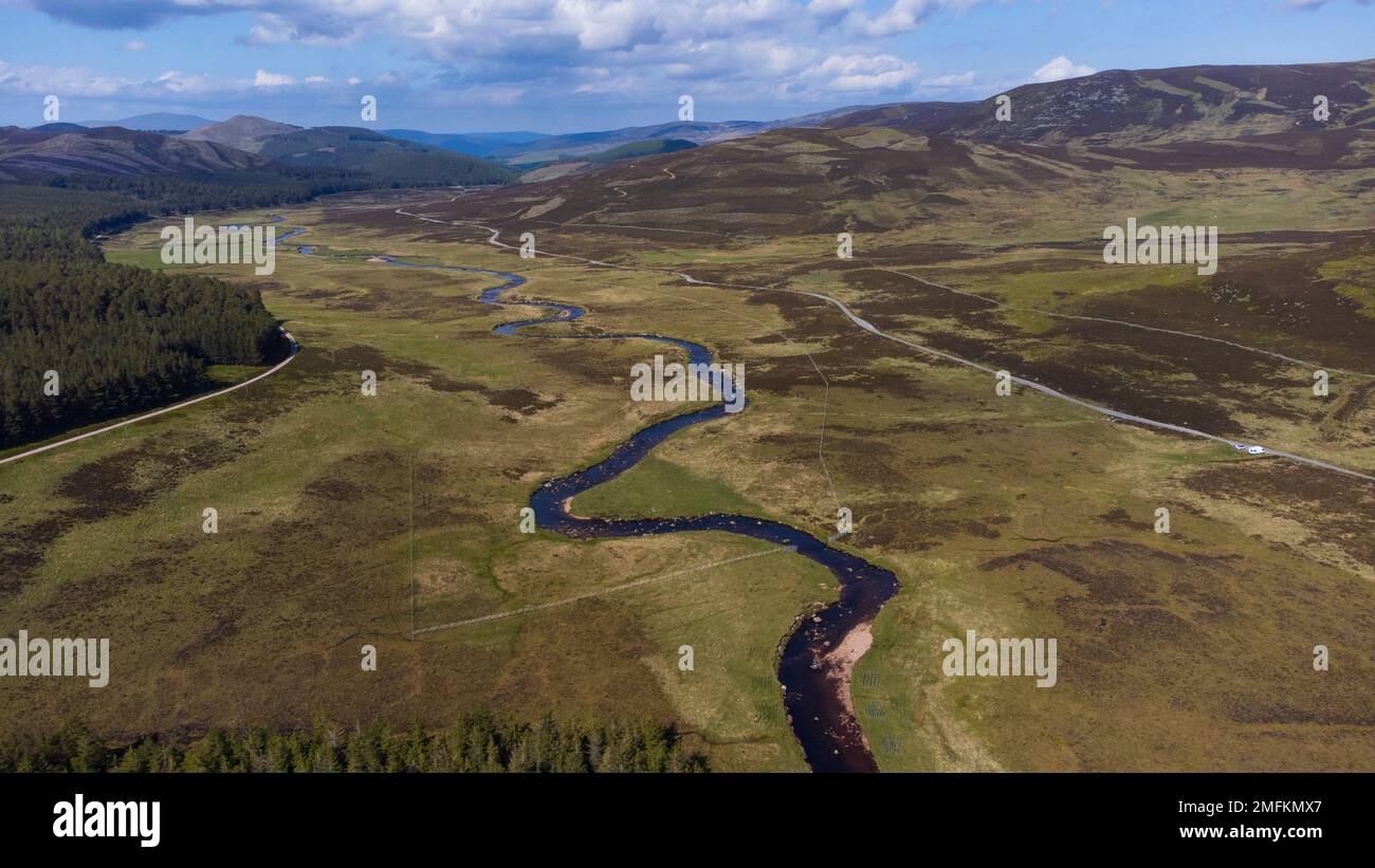 Aerial birds eye view of the River Muick and pine forest on the Balmoral Estate in the Cairngorms National Park in the Scottish Highlands of Scotland, Stock Photo
