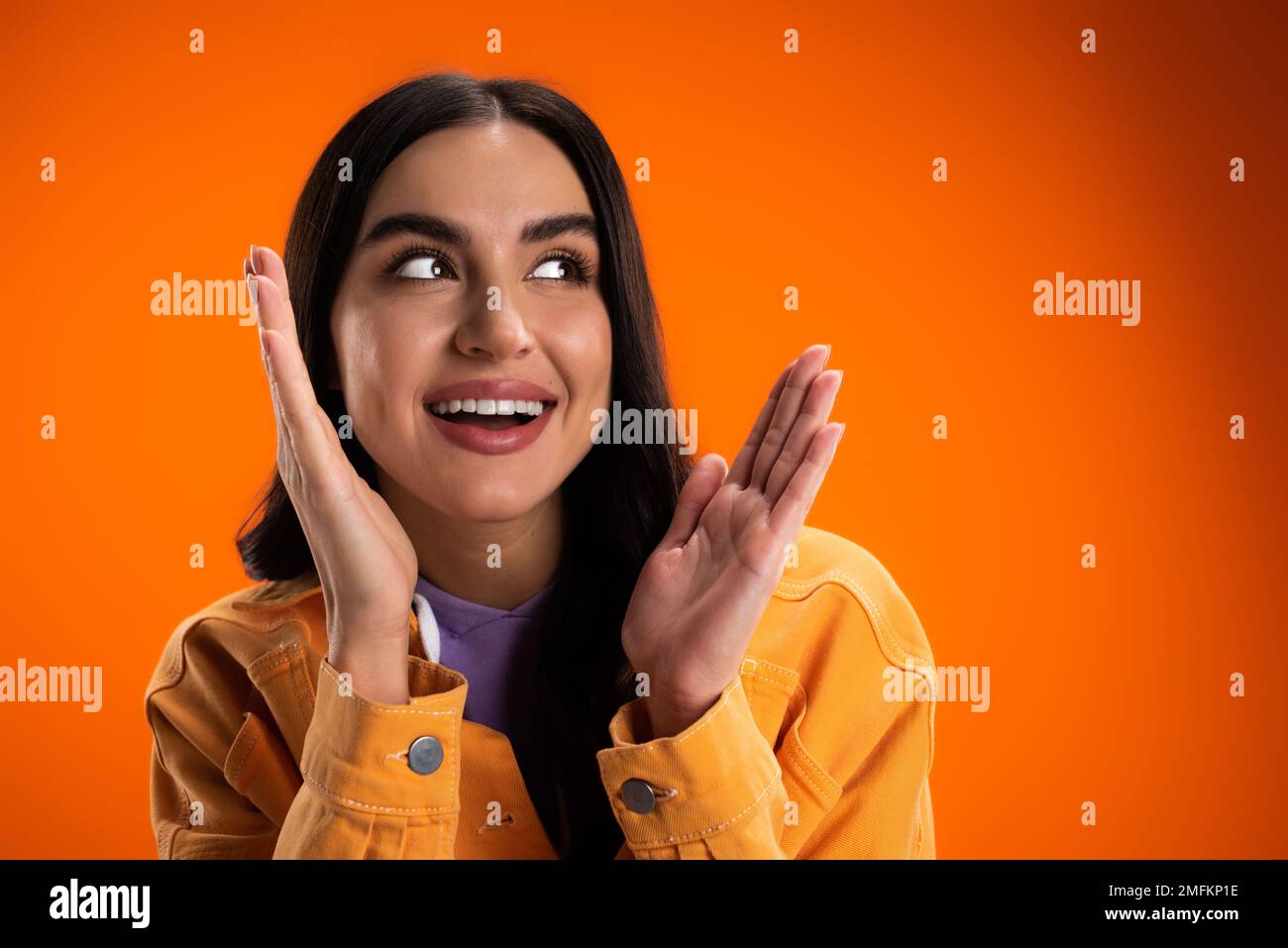 Positive woman in orange hoodie hi-res stock photography and images - Alamy