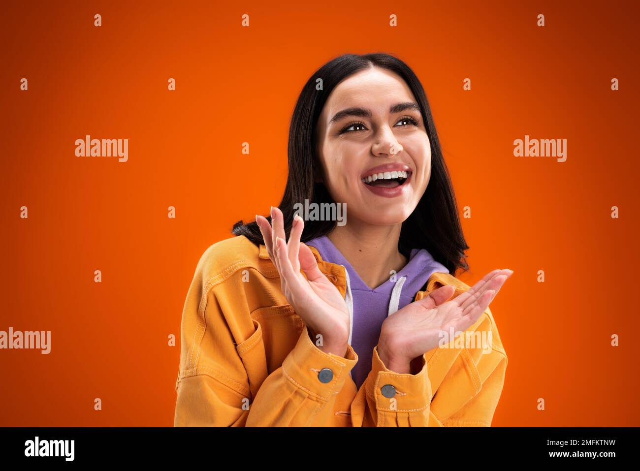 Positive woman in orange hoodie hi-res stock photography and images - Alamy