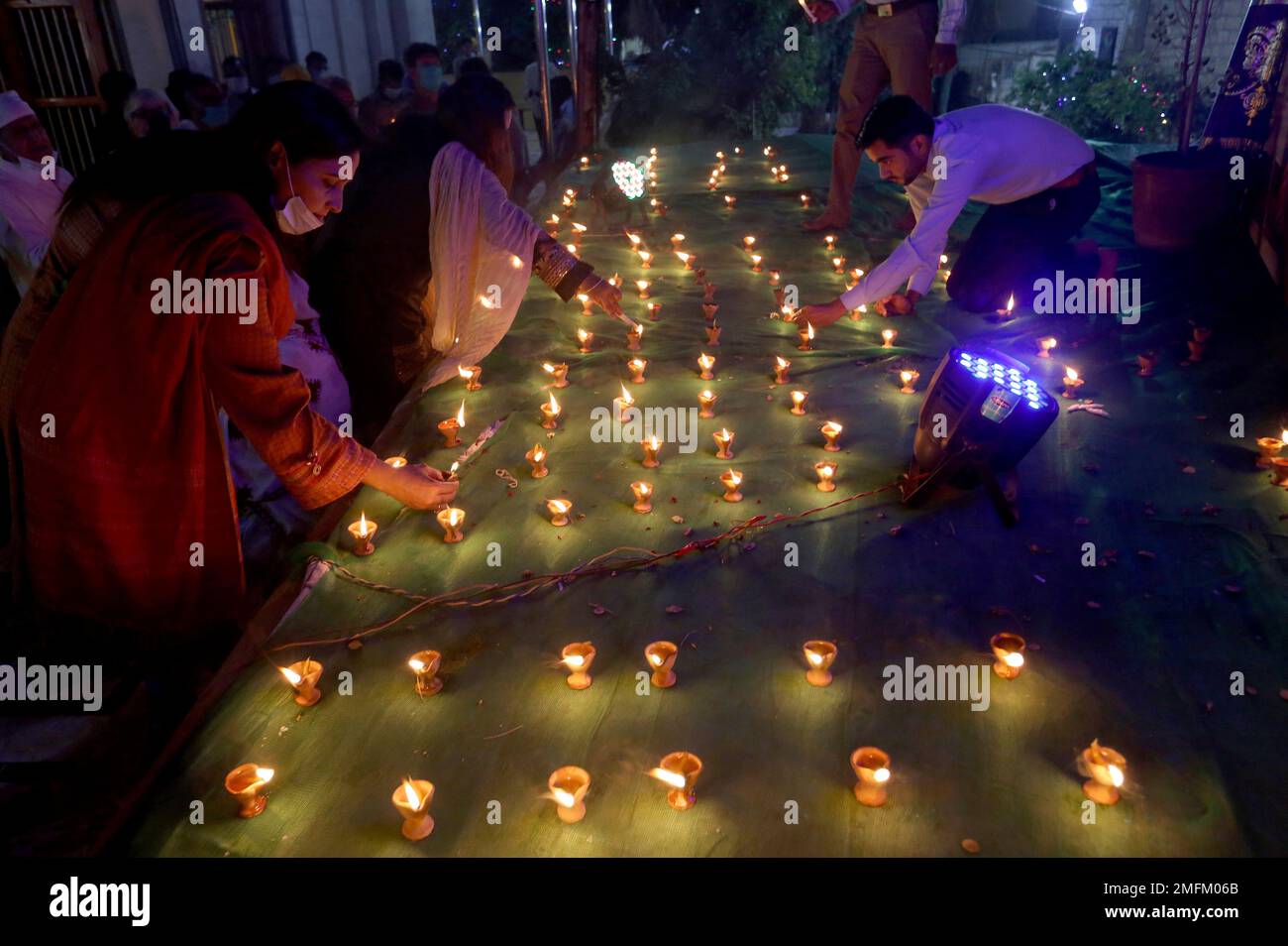 Hindu family light claylamps during a ceremony to celebrate Diwali