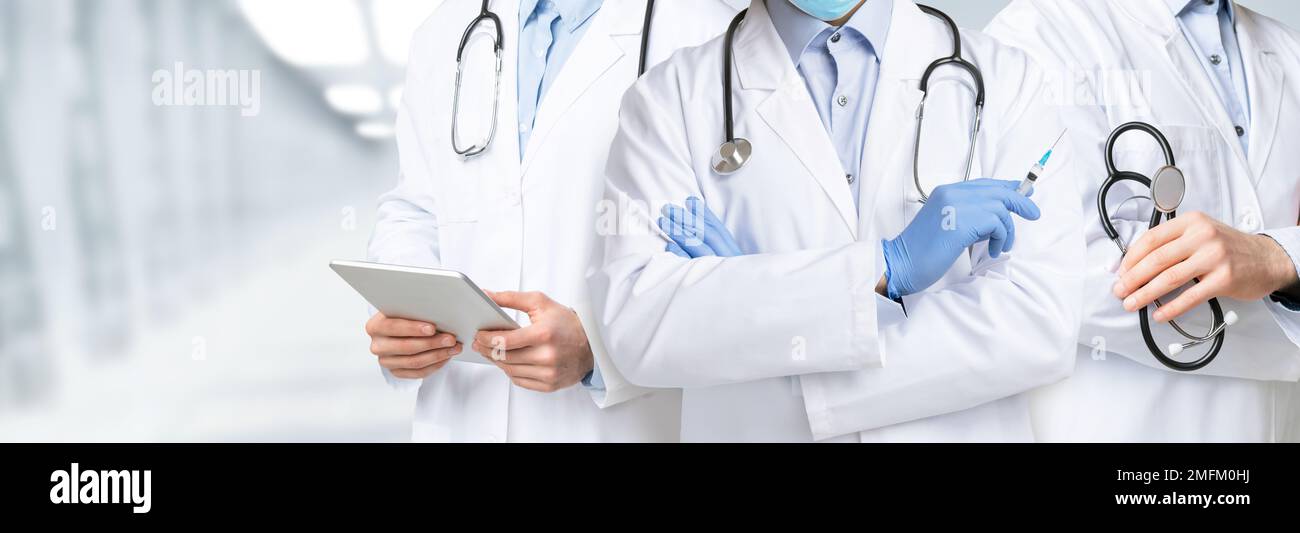 Group of male doctors posing at modern clinic, cropped shot Stock Photo ...