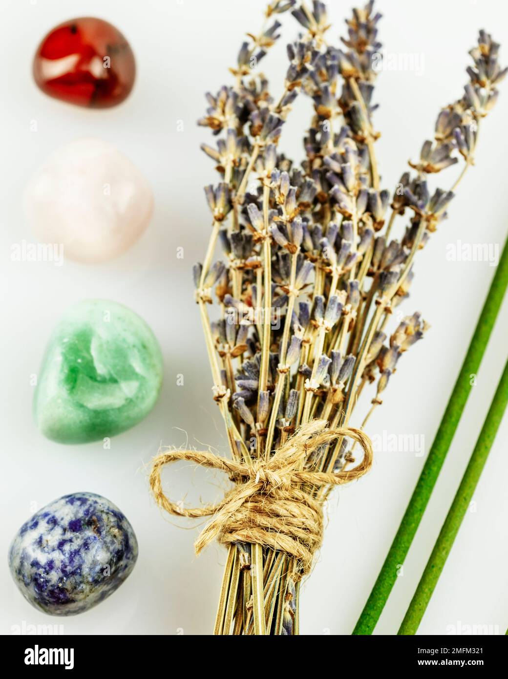 Recovering, energy healing composition with lavender flowers, aroma sticks and chakra stones on white background. Concept of relaxing, self care, medi Stock Photo
