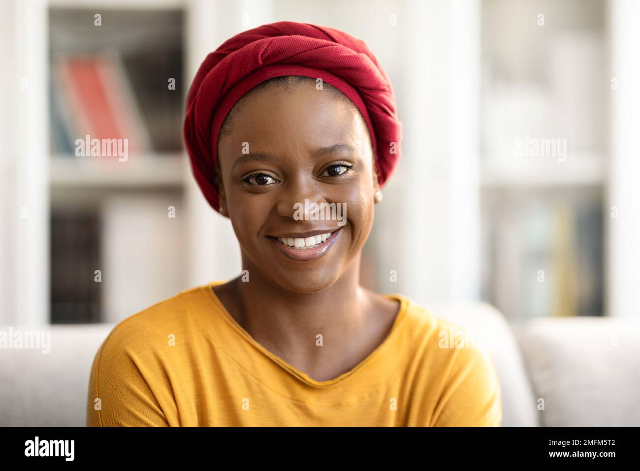 Portrait of pretty young black woman posing at home Stock Photo - Alamy