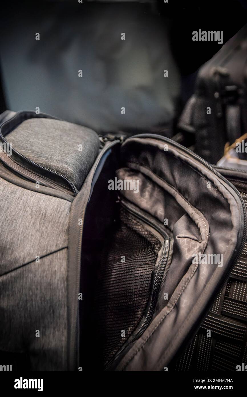 A detail of a modern dark grey half-opened backpack Stock Photo - Alamy