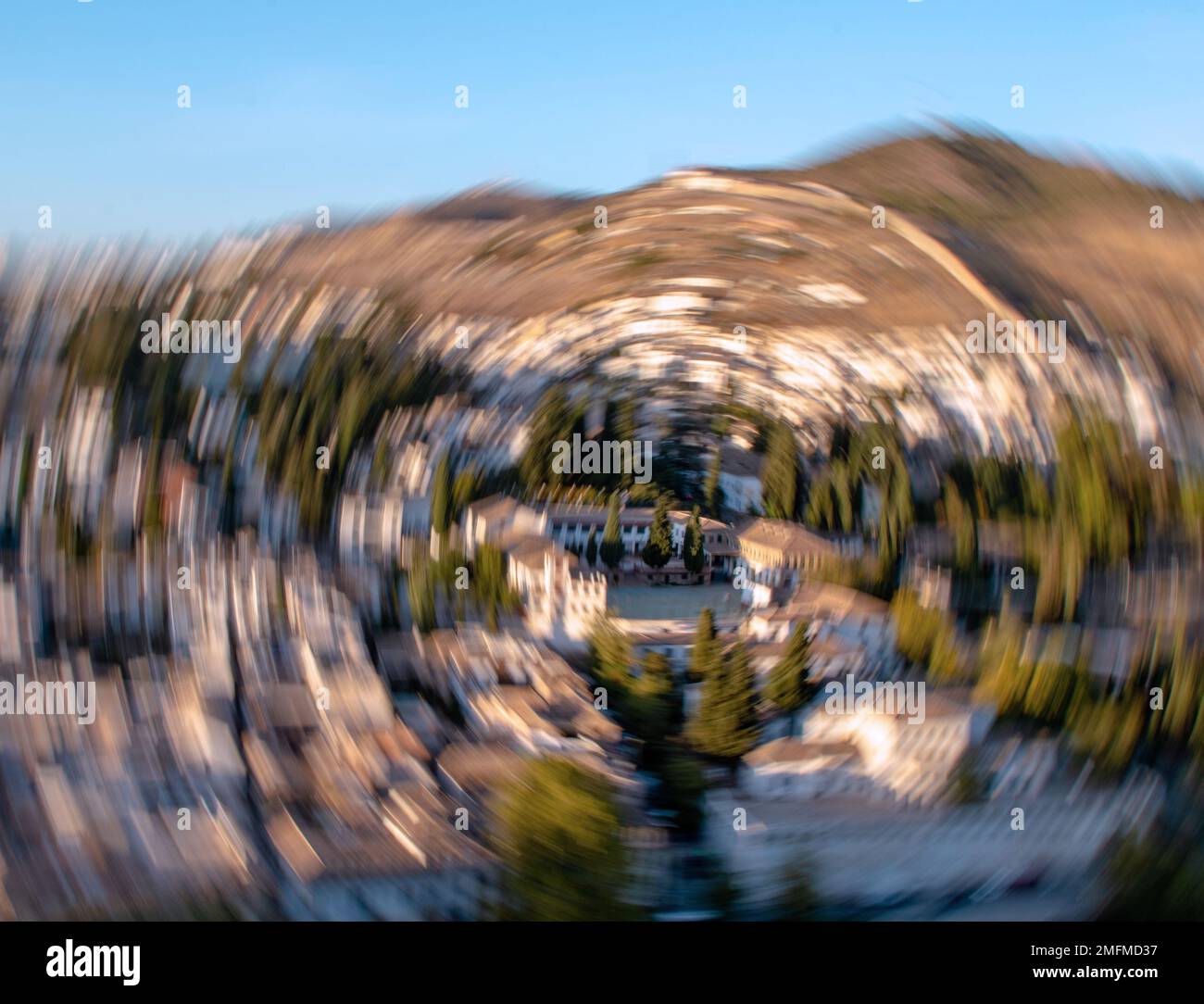 Bright photo with blurred view of the city and mountains. Stock Photo