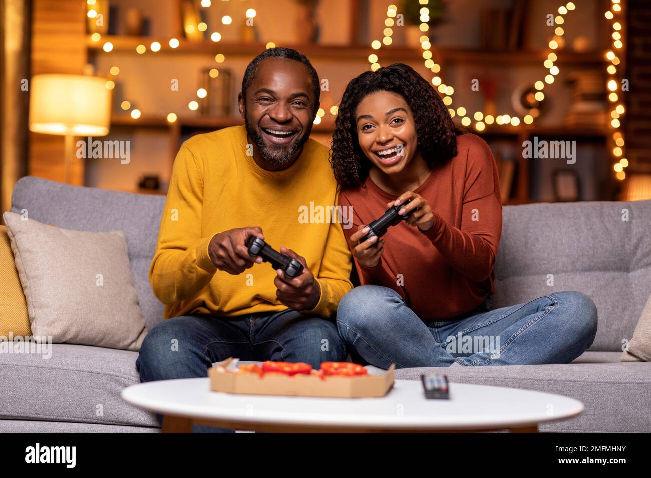 Cool african american couple playing video games at home Stock Photo