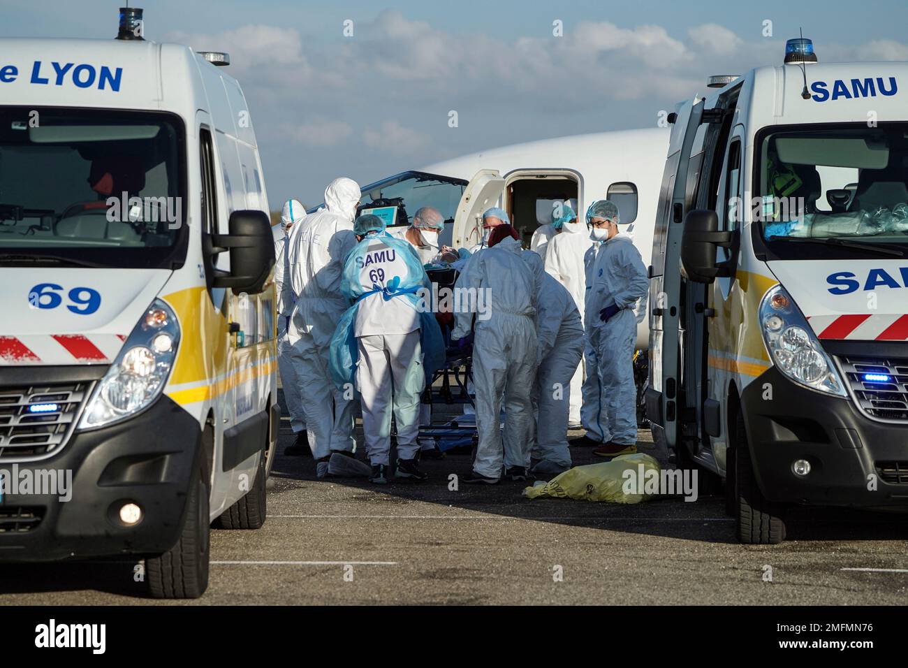 Medical staff transport a patient affected with COVID-19 to another region  from the Lyon-Bron airport, central France, Monday, Nov. 9, 2020. The  French government gradually ratcheted up from localised curfews and closures