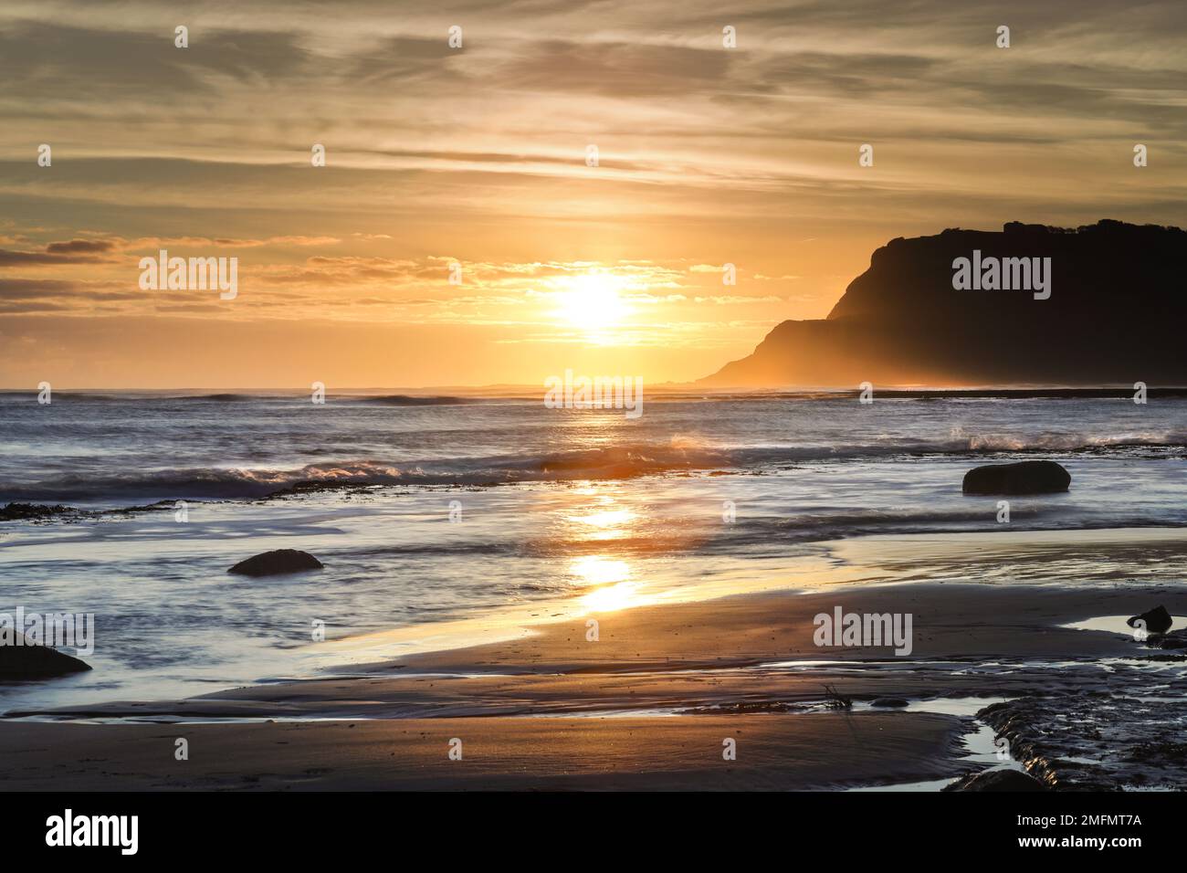 The View South East over Robin Hood’s Bay towards Ravenscar at Sunrise, North Yorkshire, UK Stock Photo