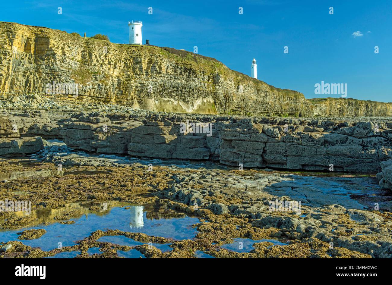 The two lighthouses seen from the beach at Nash Point on the Glamorgan Heritage Coast on a bright and sunny November day Stock Photo