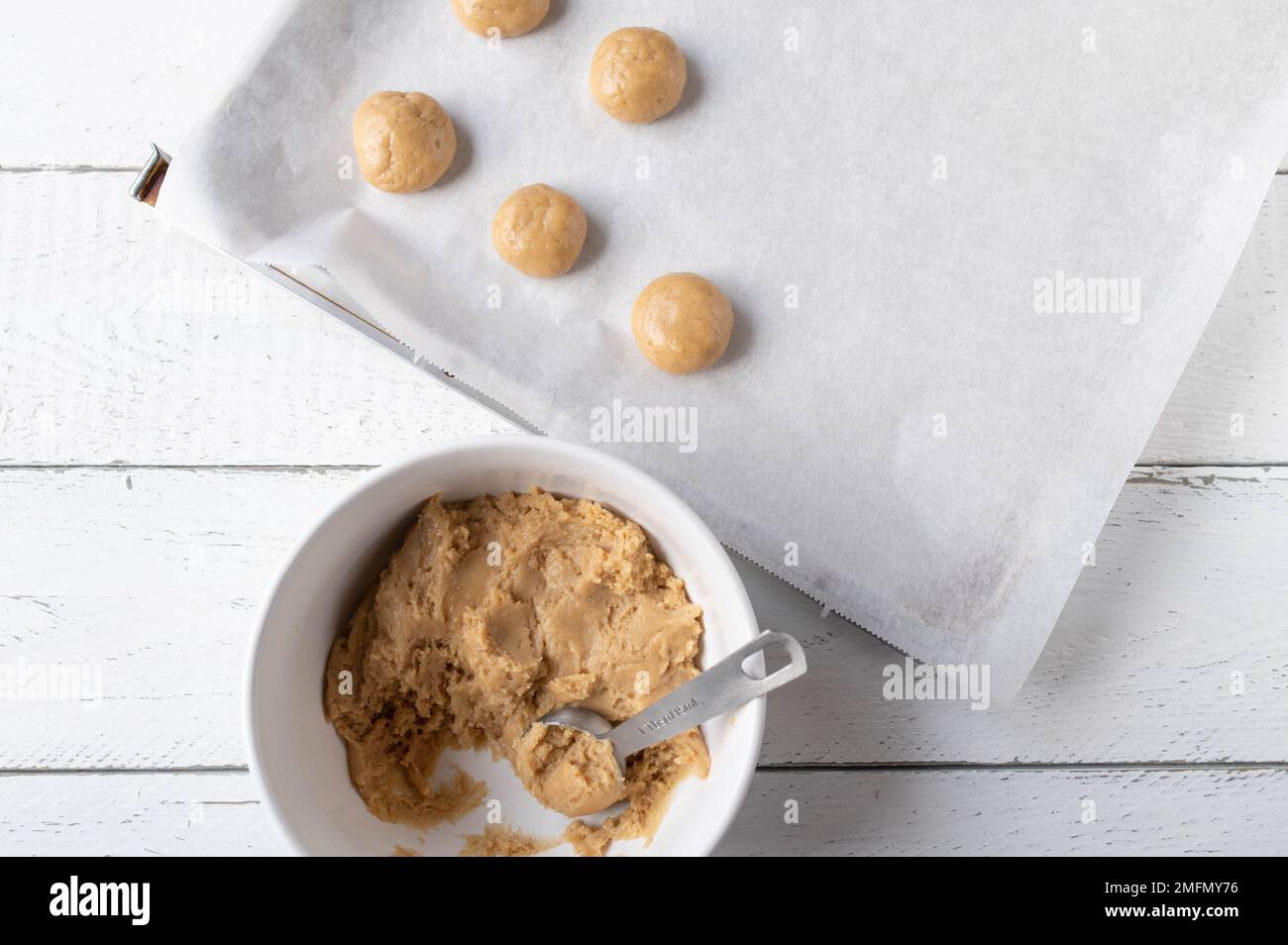 Fresh dough for making gingerbread cookies on white background in a bowl with baking sheet Stock Photo