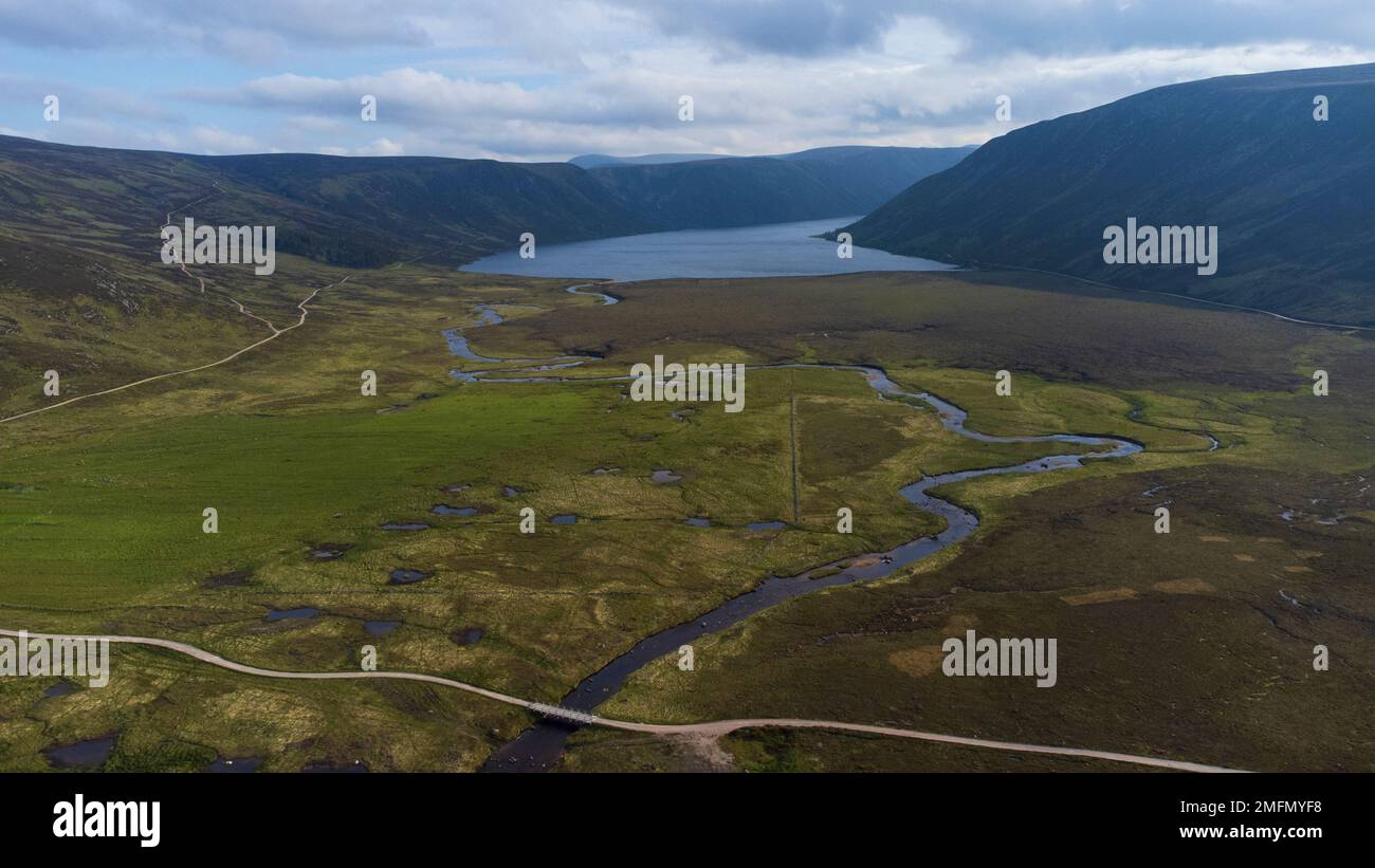 Aerial birds eye view of the River Muick and pine forest on the Balmoral Estate in the Cairngorms National Park in the Scottish Highlands of Scotland, Stock Photo