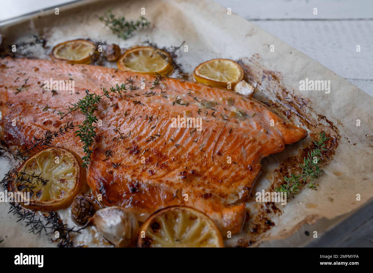 Oven roasted half salmon fillet with oilive oil, thyme, garlic and